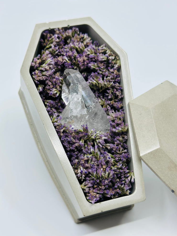 Concrete Coffin With Dried Flowers and a Clear Quartz